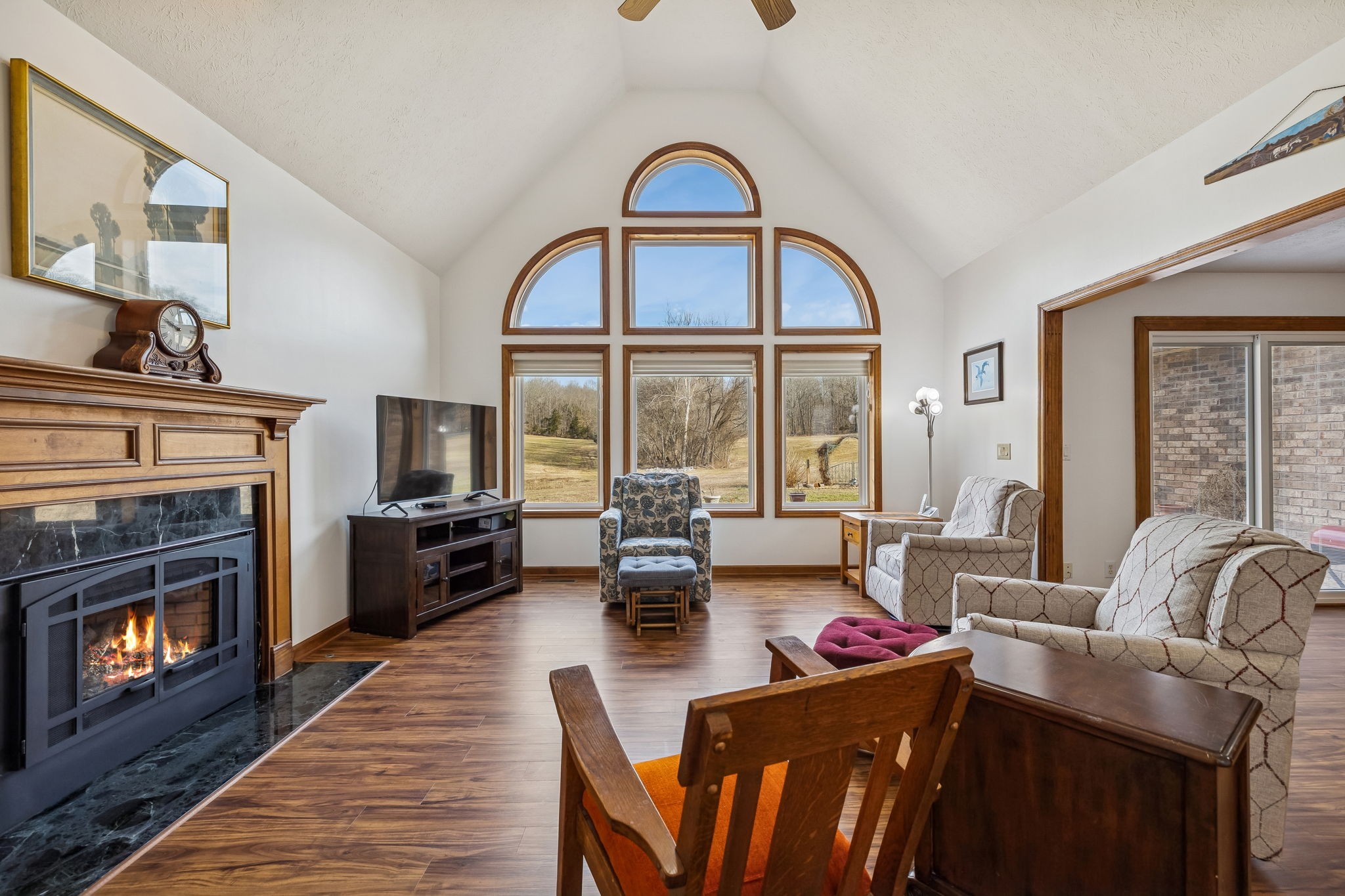 1457 Absher Branch Road Westmoreland, TN 37186 - Photo 8 of 74 a living room with furniture a fireplace a flat screen tv and floor to ceiling window