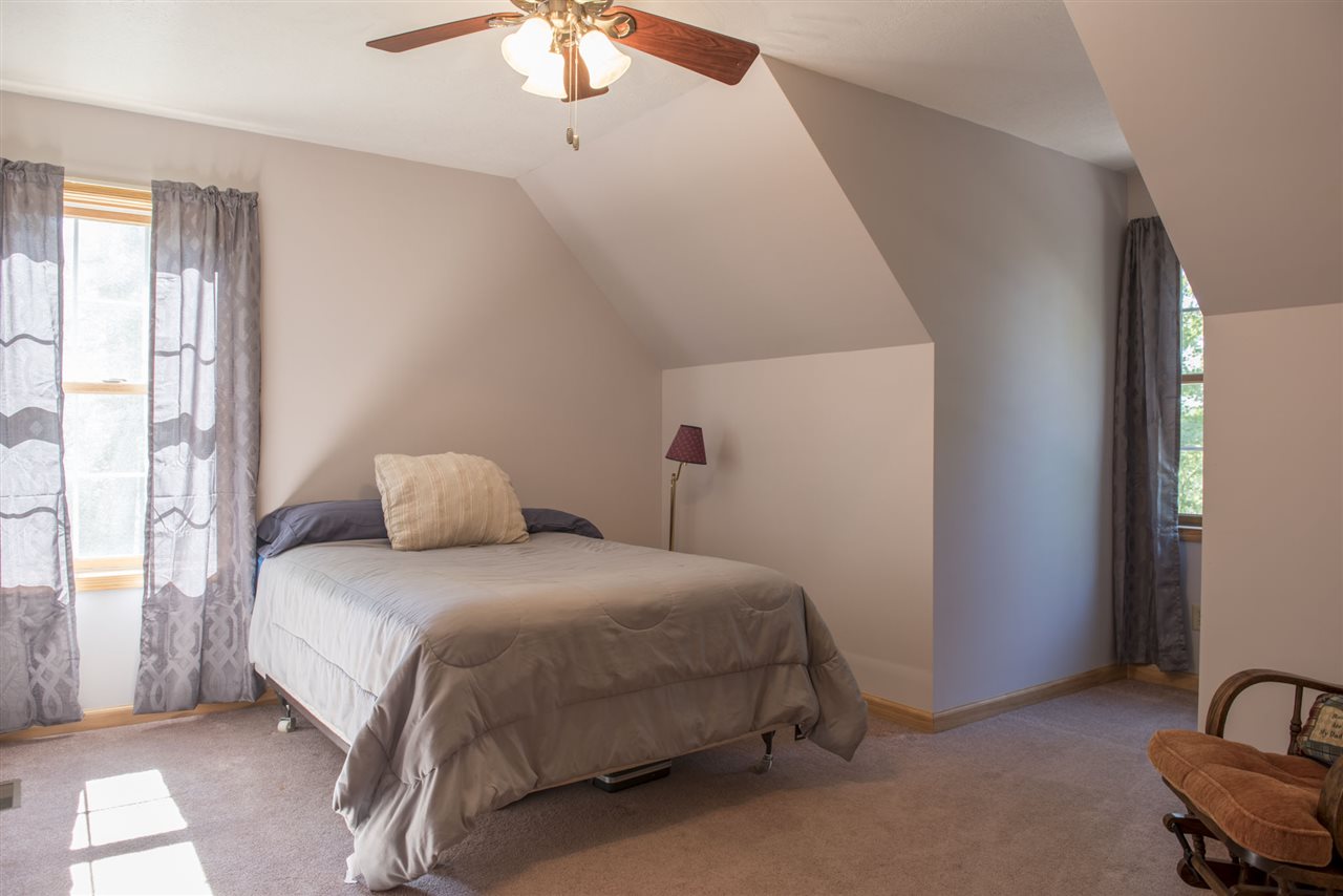 5979 Faughts Road Mount Crawford, VA 22841 - Photo 8 of 18 a bedroom with a bed and a chandelier