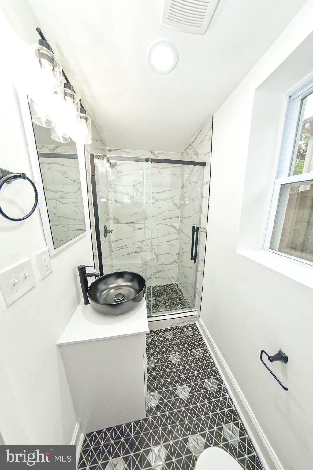 3704 Suitland Road Southeast Washington, DC 20020 - Photo 49 of 70 a bathroom with a sink a toilet and shower