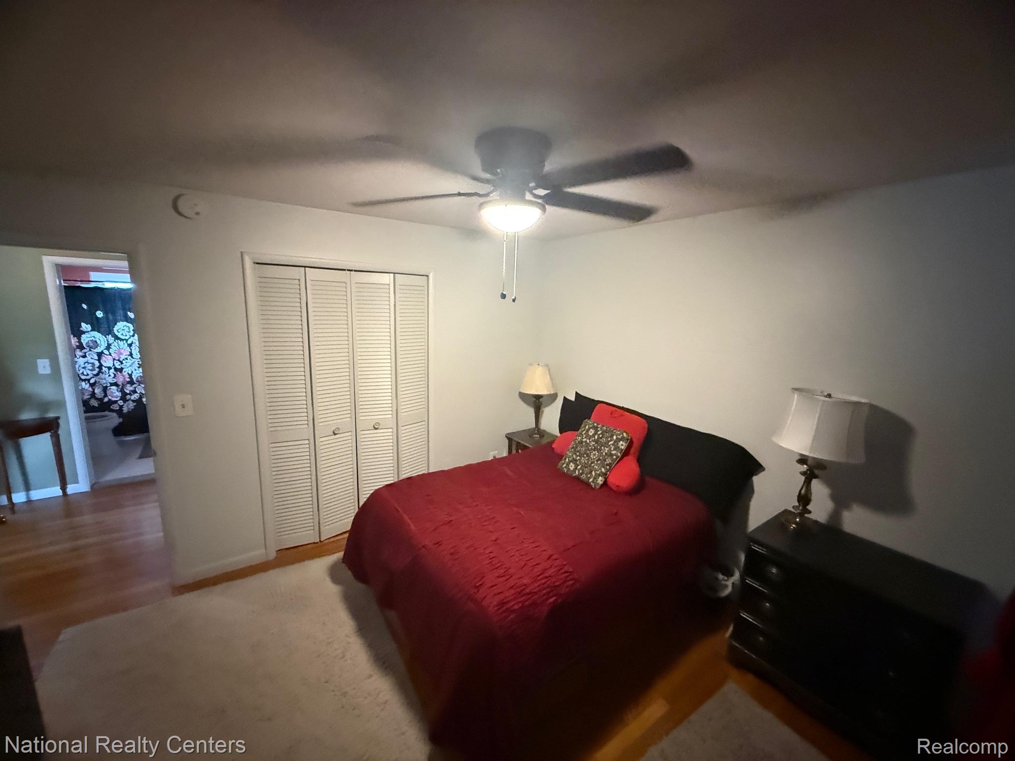 9920 Farmington Road Livonia, MI 48150 - Photo 10 of 20 Hardwood flooring, ceiling fan with integrated lighting, louvered bi-fold closet doors, and light-toned wall paint