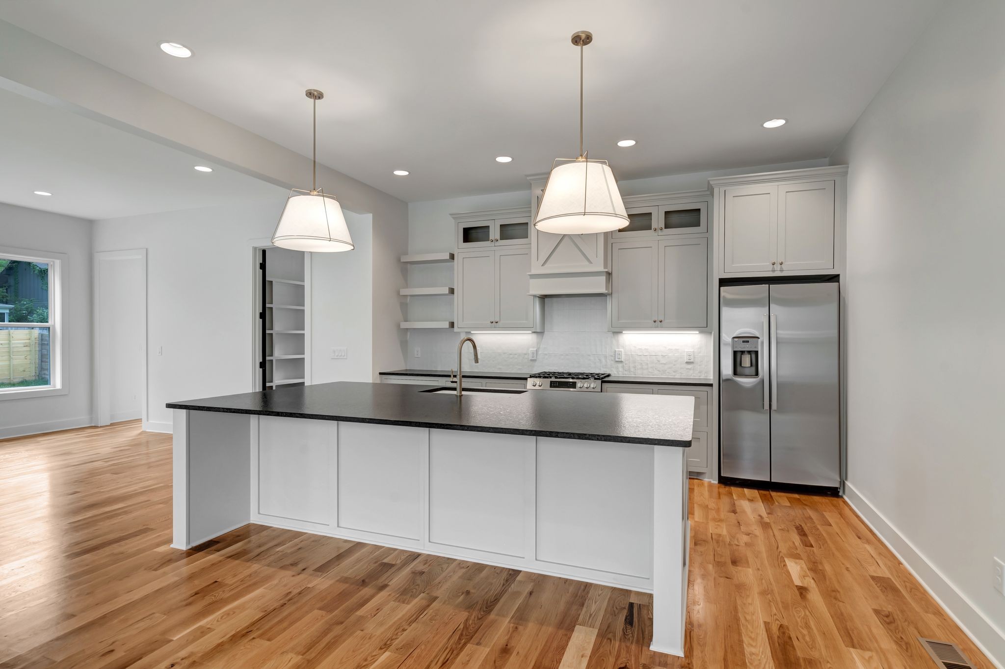 1826 Cephas Street Nashville, TN 37208 - Photo 13 of 35 a kitchen with stainless steel appliances granite countertop a sink a stove and a wooden floors