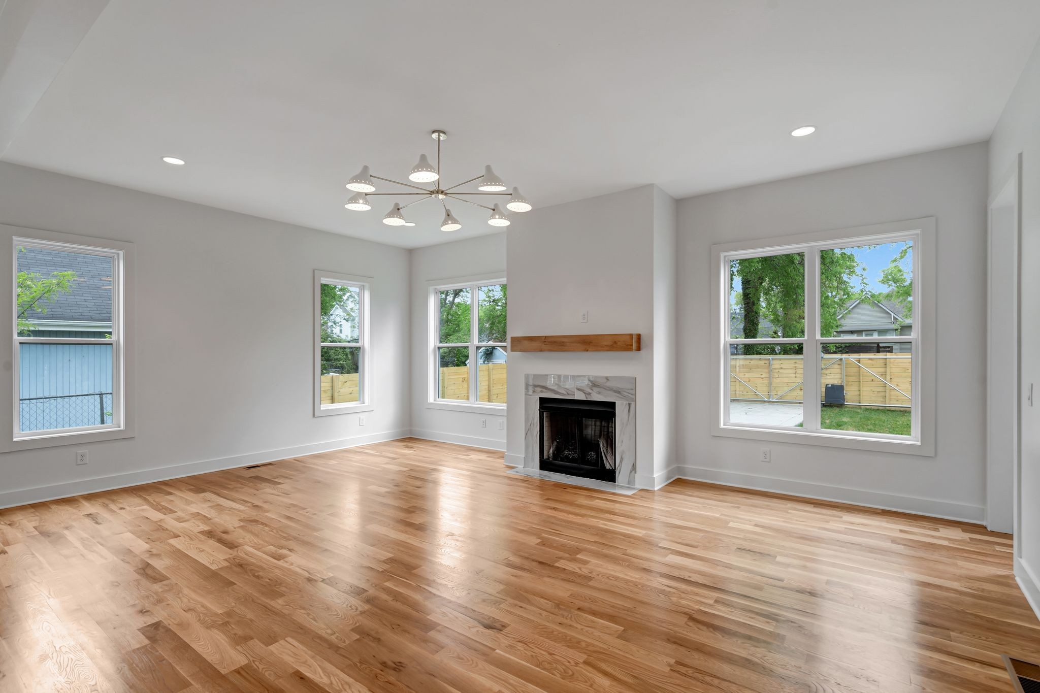 1826 Cephas Street Nashville, TN 37208 - Photo 17 of 35 an empty room with windows fireplace and wooden floor