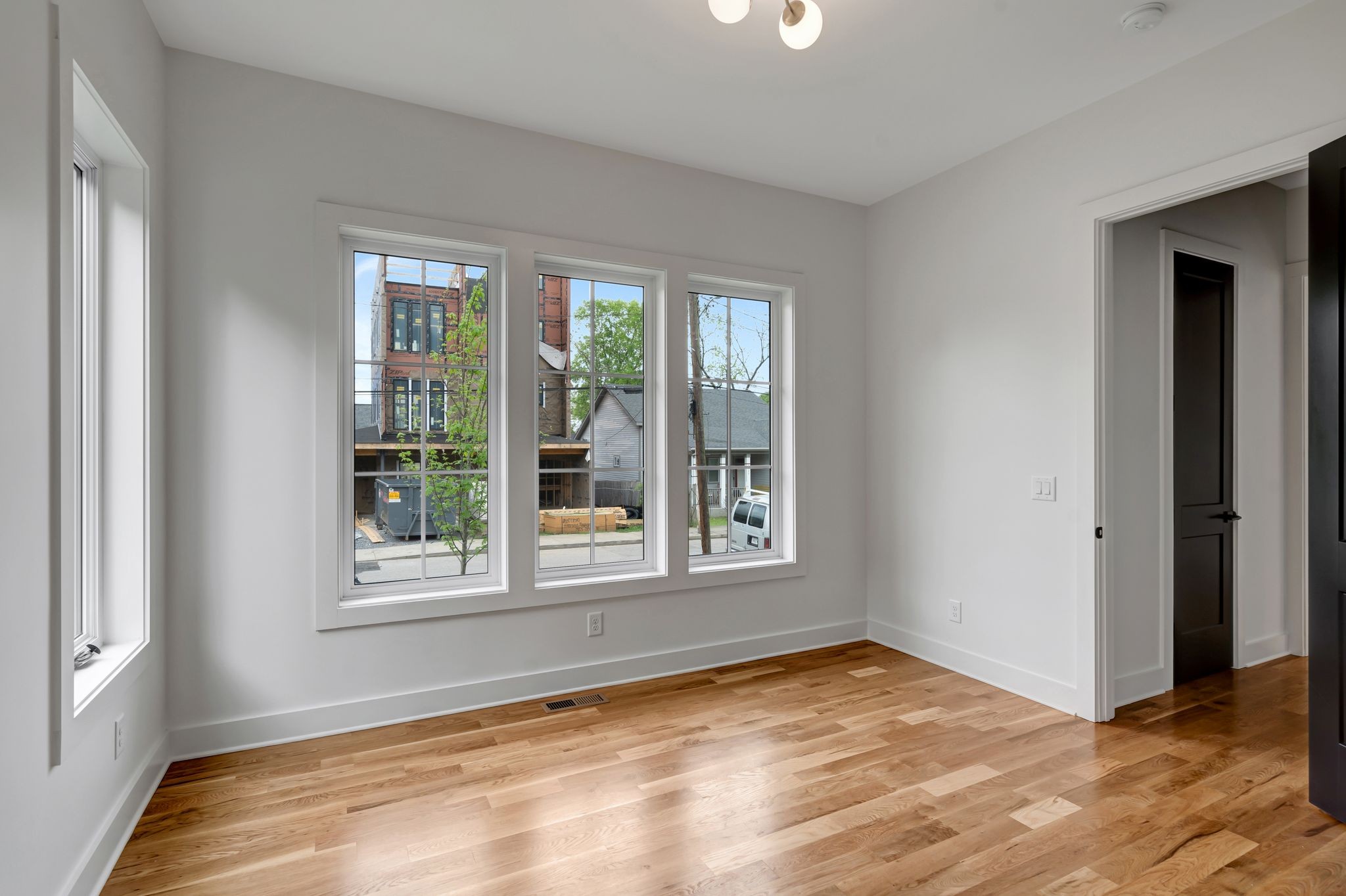 1826 Cephas Street Nashville, TN 37208 - Photo 8 of 35 an empty room with wooden floor and windows