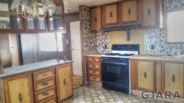 2234 H Road Grand Junction, CO 81505 - Photo 3 of 9 a kitchen with stainless steel appliances granite countertop a stove and a refrigerator