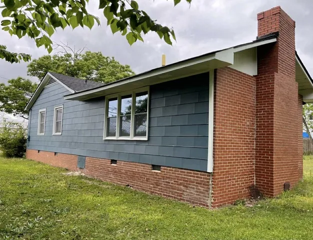 a brick house with a large window