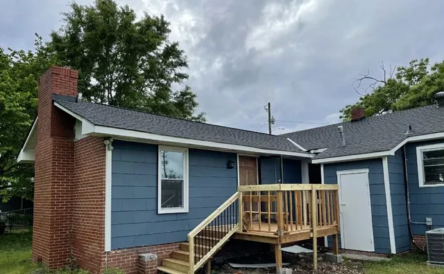 a roof deck with table and chairs