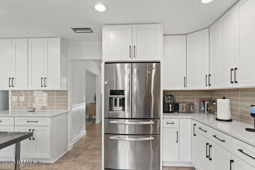 9480 Pickwick Drive Jacksonville, FL 32257 - Photo 18 of 43 a kitchen with refrigerator a sink and cabinets