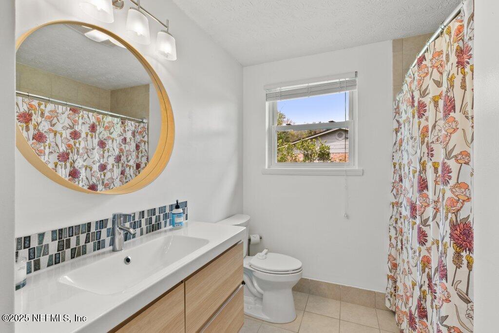 9480 Pickwick Drive Jacksonville, FL 32257 - Photo 24 of 43 a bathroom with a sink and a mirror