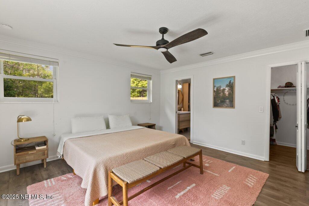 9480 Pickwick Drive Jacksonville, FL 32257 - Photo 30 of 43 a bedroom with a bed and wooden floor