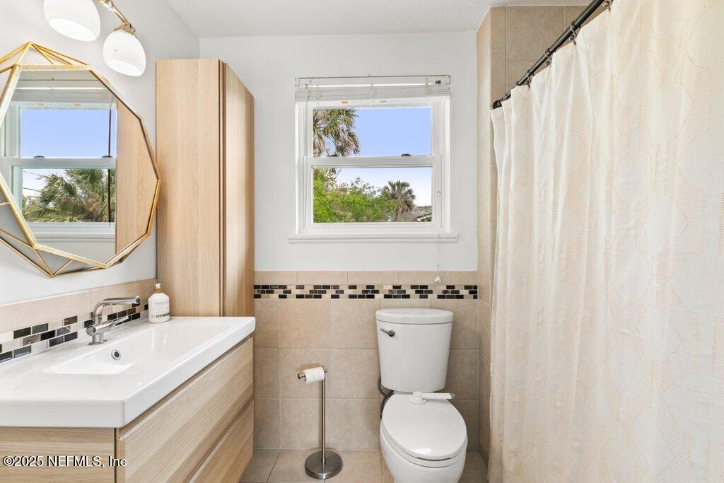 9480 Pickwick Drive Jacksonville, FL 32257 - Photo 31 of 43 a bathroom with a sink mirror vanity and toilet
