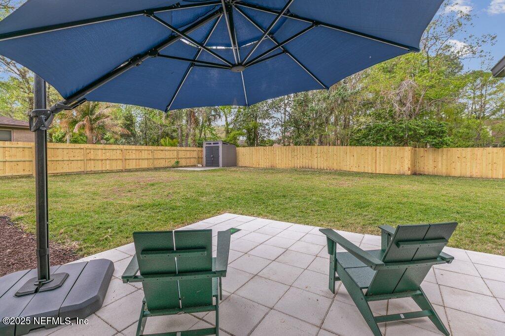 9480 Pickwick Drive Jacksonville, FL 32257 - Photo 34 of 43 a view of a balcony with chair and an umbrella