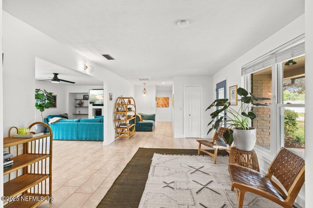 9480 Pickwick Drive Jacksonville, FL 32257 - Photo 9 of 43 a living room with furniture a wooden floor and next to a window