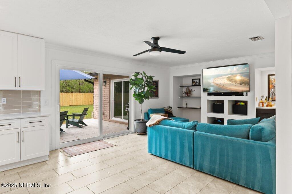 9480 Pickwick Drive Jacksonville, FL 32257 - Photo 10 of 43 a living room with furniture and a flat screen tv