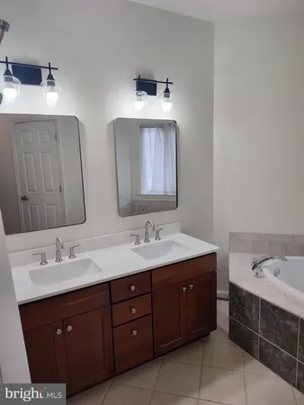 a bathroom with a double vanity sink and mirror