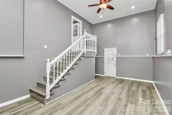 a view of entryway and hall with wooden floor