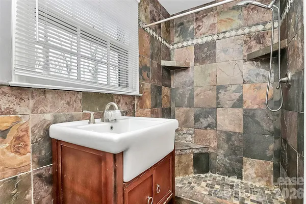 a bathroom with a sink vanity and tub