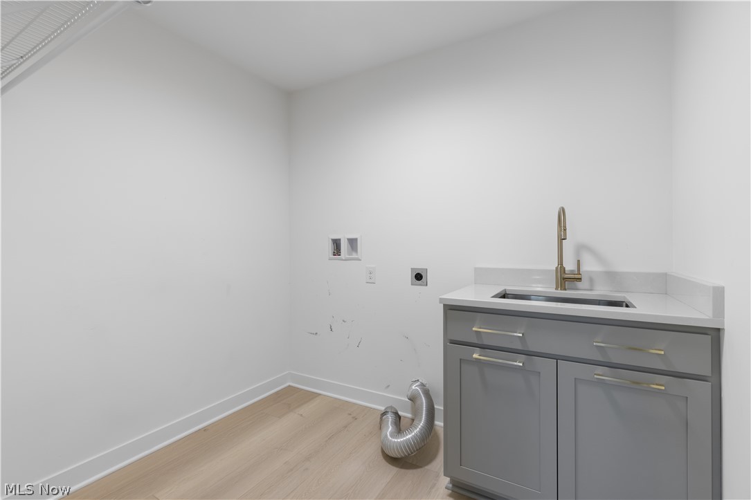 35799 Lorain Road North Ridgeville, OH 44039 - Photo 22 of 50 1st Floor Utility Room/Clothes washing area with washer hookup, electric dryer hookup, light hardwood / wood-style flooring, and sink