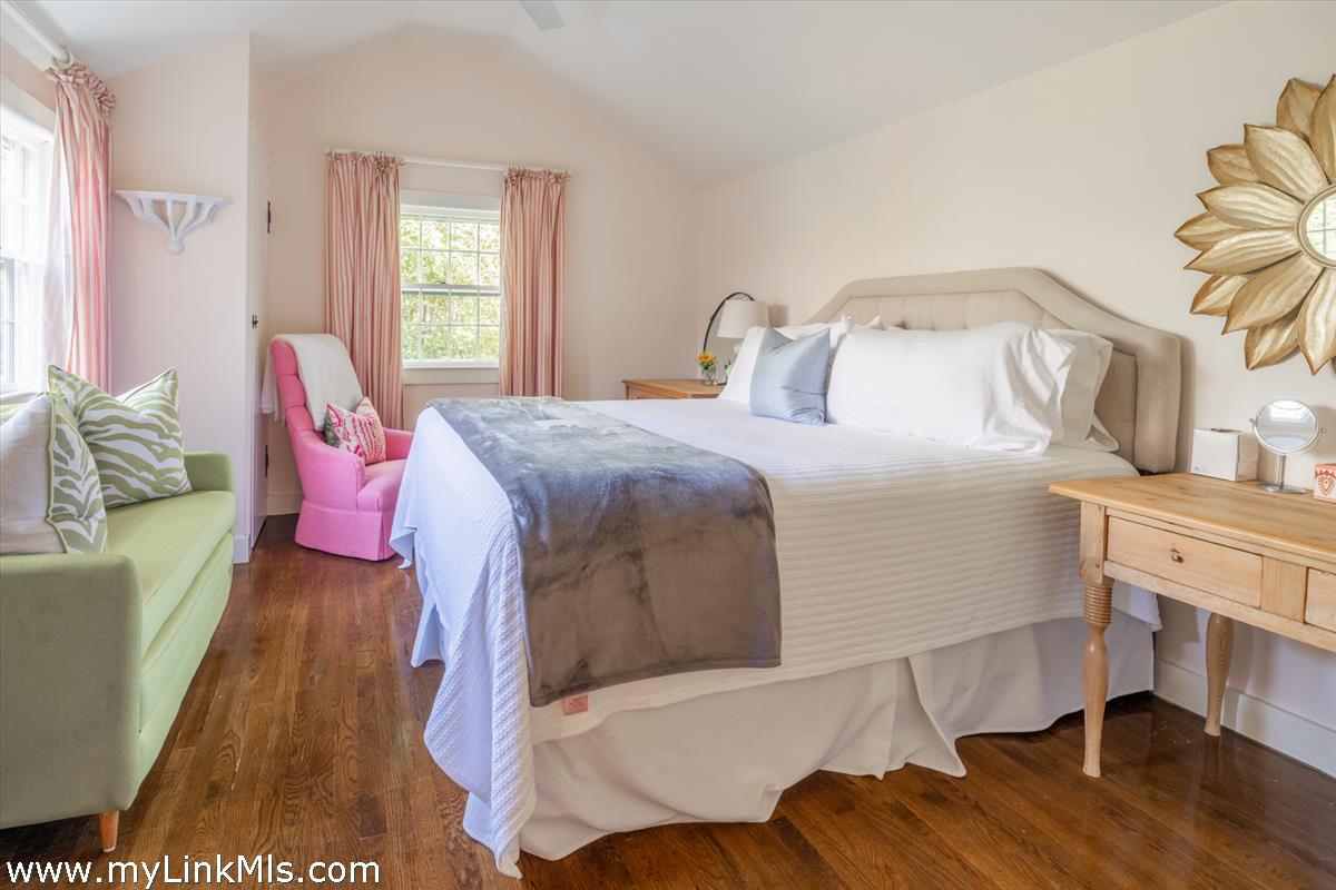14 & 16 Coffin Street Nantucket, MA 02554 - Photo 16 of 50 a bed room with a bed and a chair