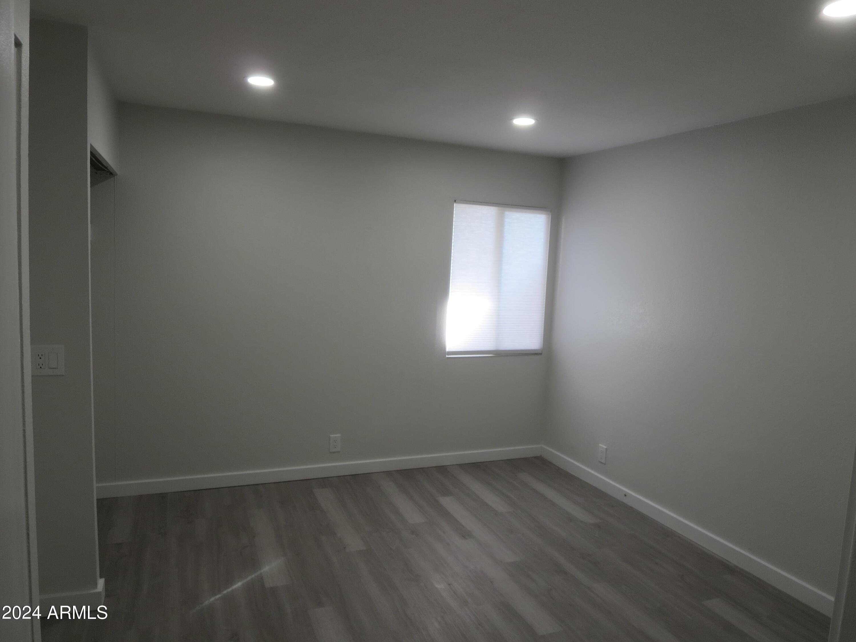 1450 East Bethany Home Road, Unit 34 Phoenix, AZ 85014 - Photo 8 of 15 a view of empty room with wooden floor and fan