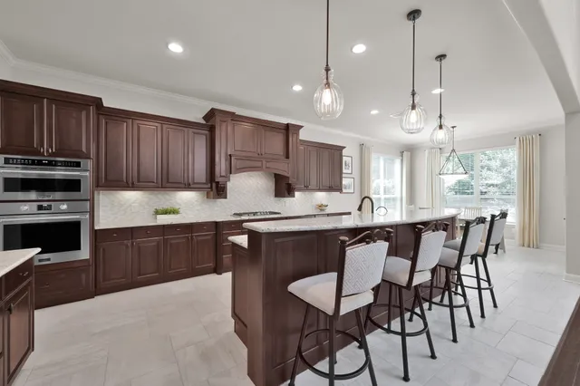 a kitchen with a table chairs microwave and cabinets