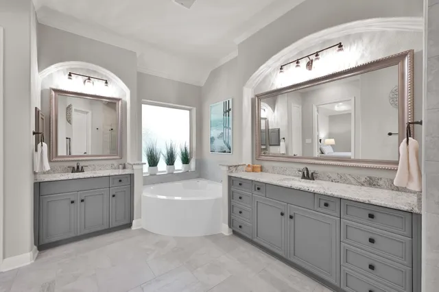a spacious bathroom with a tub sink shower and mirror