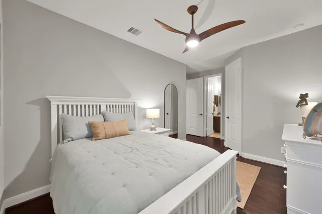 a bedroom with a large bed and a dresser