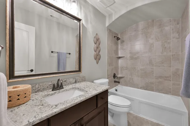 a living room with furniture and a ceiling fan
