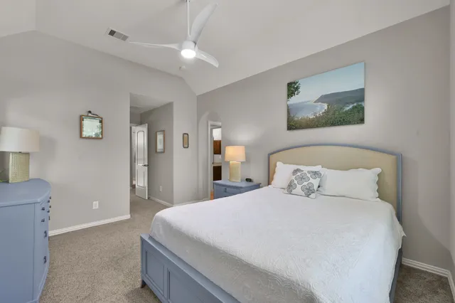 a bedroom with a large bed and a window