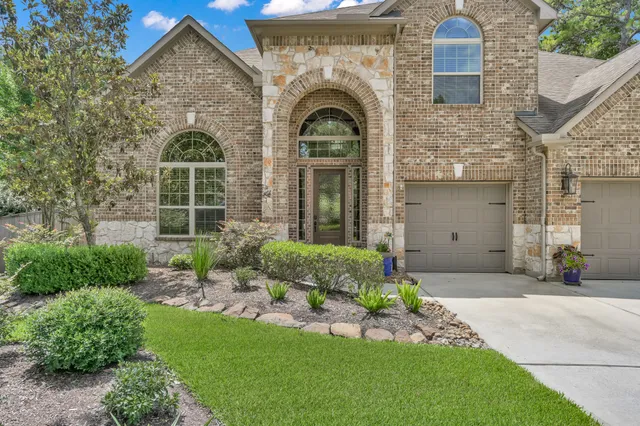 a front view of a house with a garden