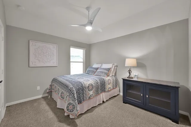 a bathroom with a granite countertop sink vanity and mirror