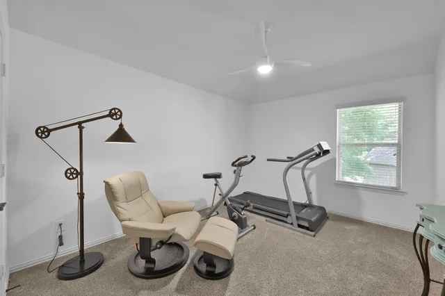 a bedroom with a bed and a lamp