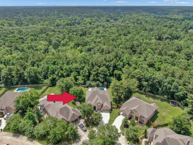 an aerial view of a house with outdoor space and street view