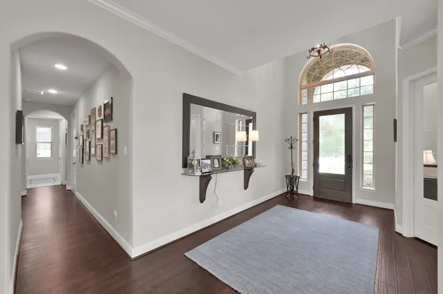a view of a livingroom with wooden floor and a large window