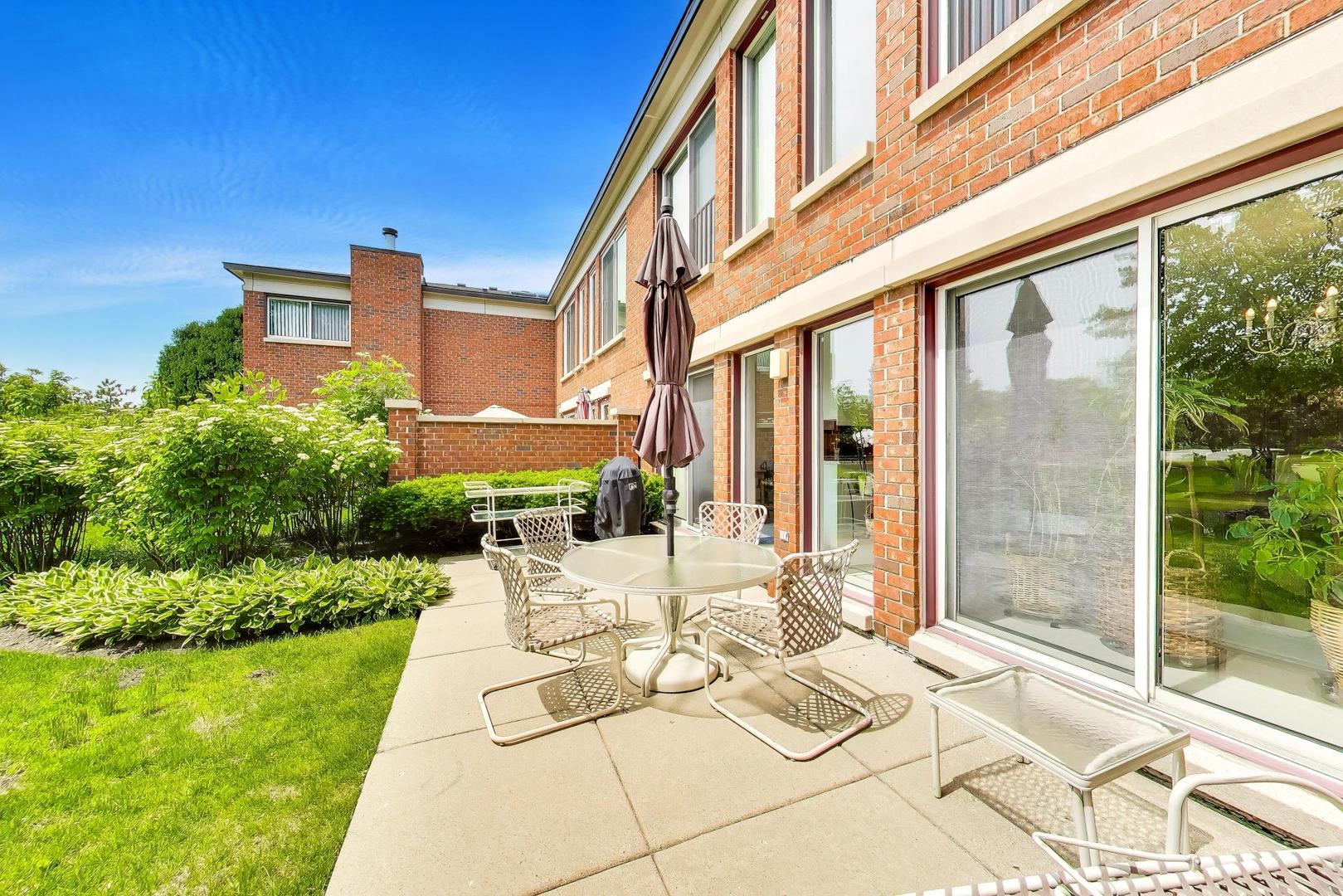 495 Milford Road Deerfield, IL 60015 - Photo 30 of 33 a view of a patio with couches and table and chairs and potted plants