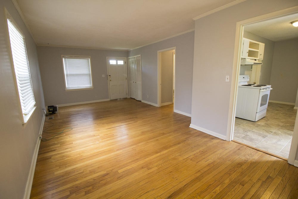 630 Robertsville Road Oak Ridge, TN 37830 - Photo 12 of 21 an empty room with wooden floor and windows