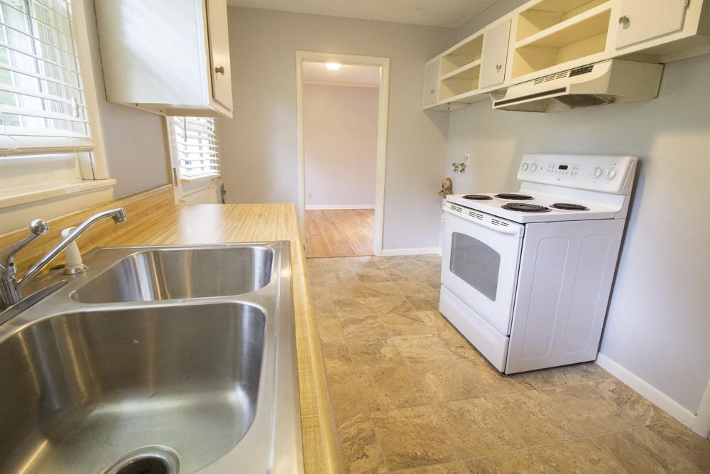 630 Robertsville Road Oak Ridge, TN 37830 - Photo 13 of 21 a kitchen with stainless steel appliances granite countertop a sink and a cabinets
