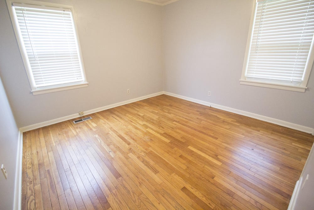 630 Robertsville Road Oak Ridge, TN 37830 - Photo 19 of 21 an empty room with wooden floor and windows