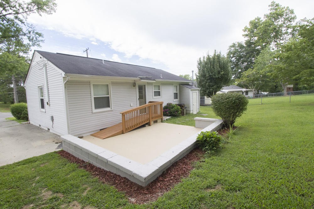 630 Robertsville Road Oak Ridge, TN 37830 - Photo 7 of 21 a view of a white house with a big yard and potted plants