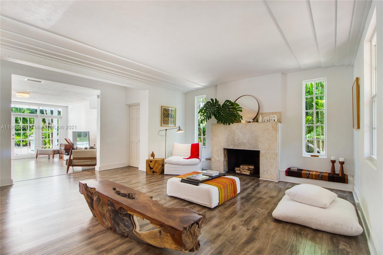 a living room with furniture fireplace and window