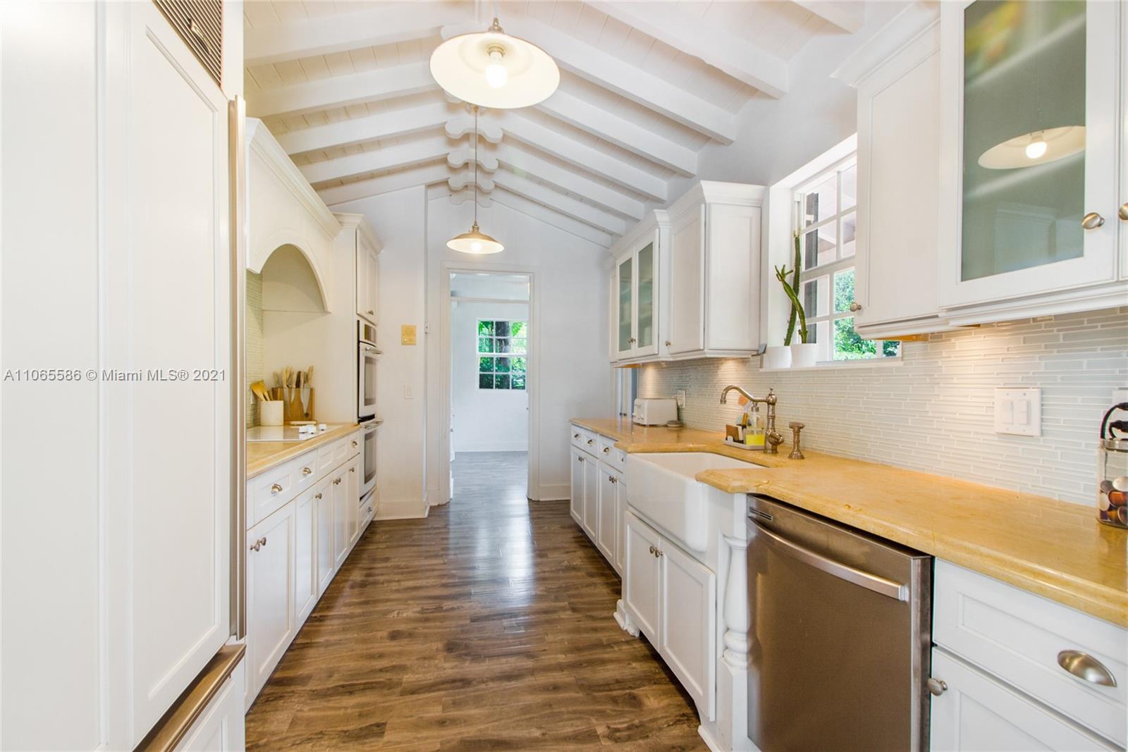 1701 Micanopy Avenue Miami, FL 33133 - Photo 11 of 40 a kitchen with a sink and a refrigerator