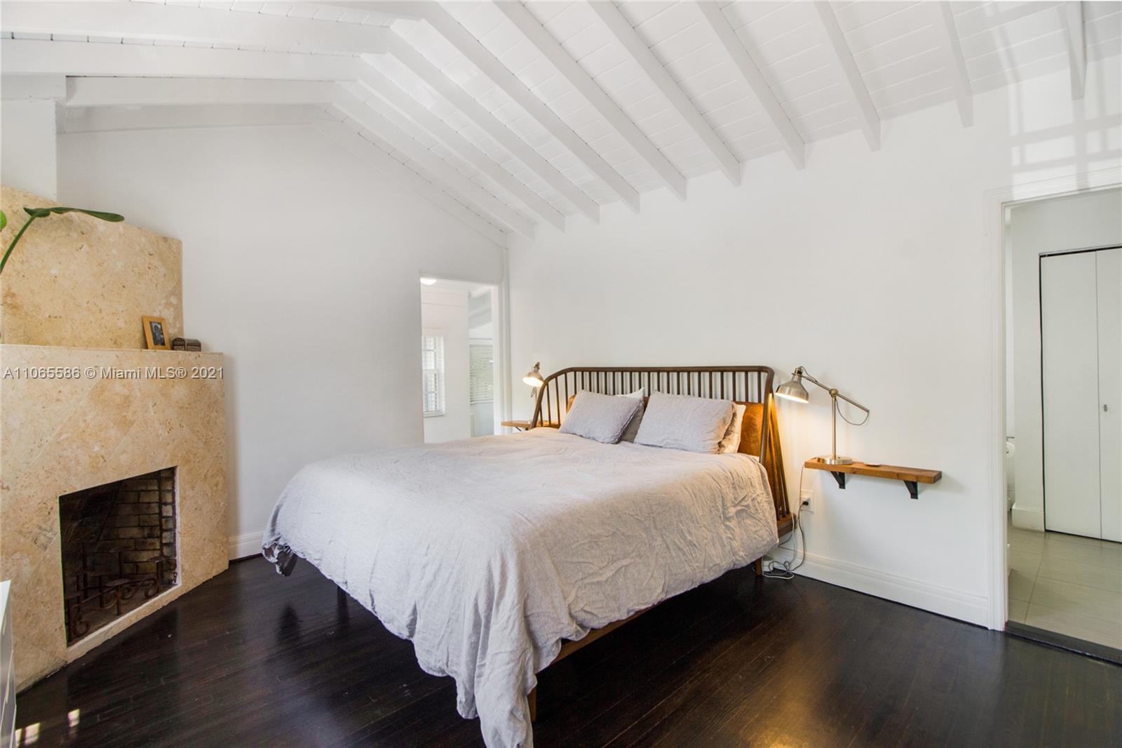 1701 Micanopy Avenue Miami, FL 33133 - Photo 13 of 40 a bedroom with a bed and wooden floor