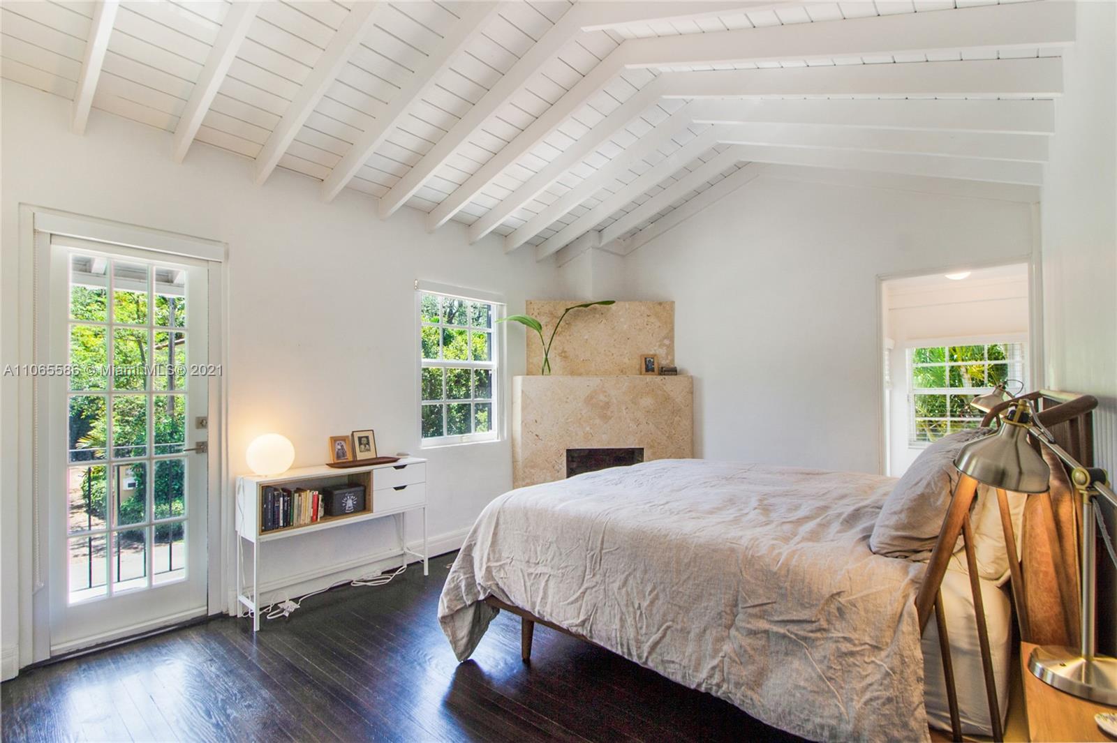 1701 Micanopy Avenue Miami, FL 33133 - Photo 14 of 40 a bed sitting in a spacious bedroom next to a window