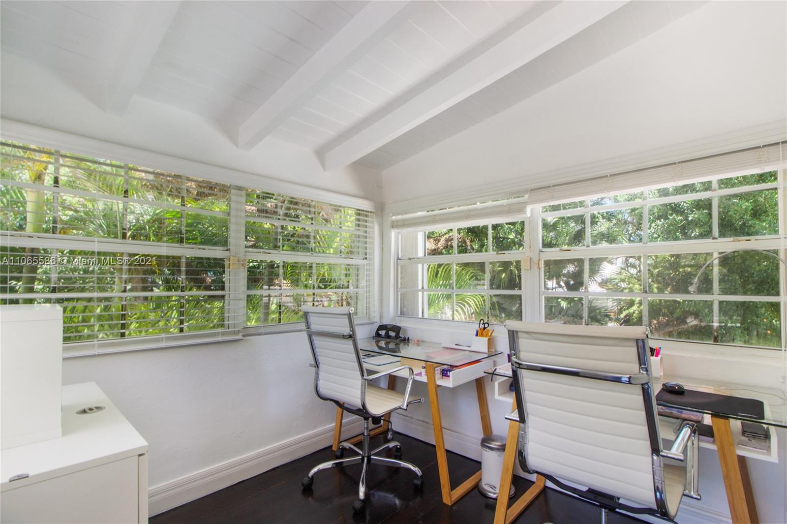 1701 Micanopy Avenue Miami, FL 33133 - Photo 15 of 40 a view of a workspace with furniture and a window