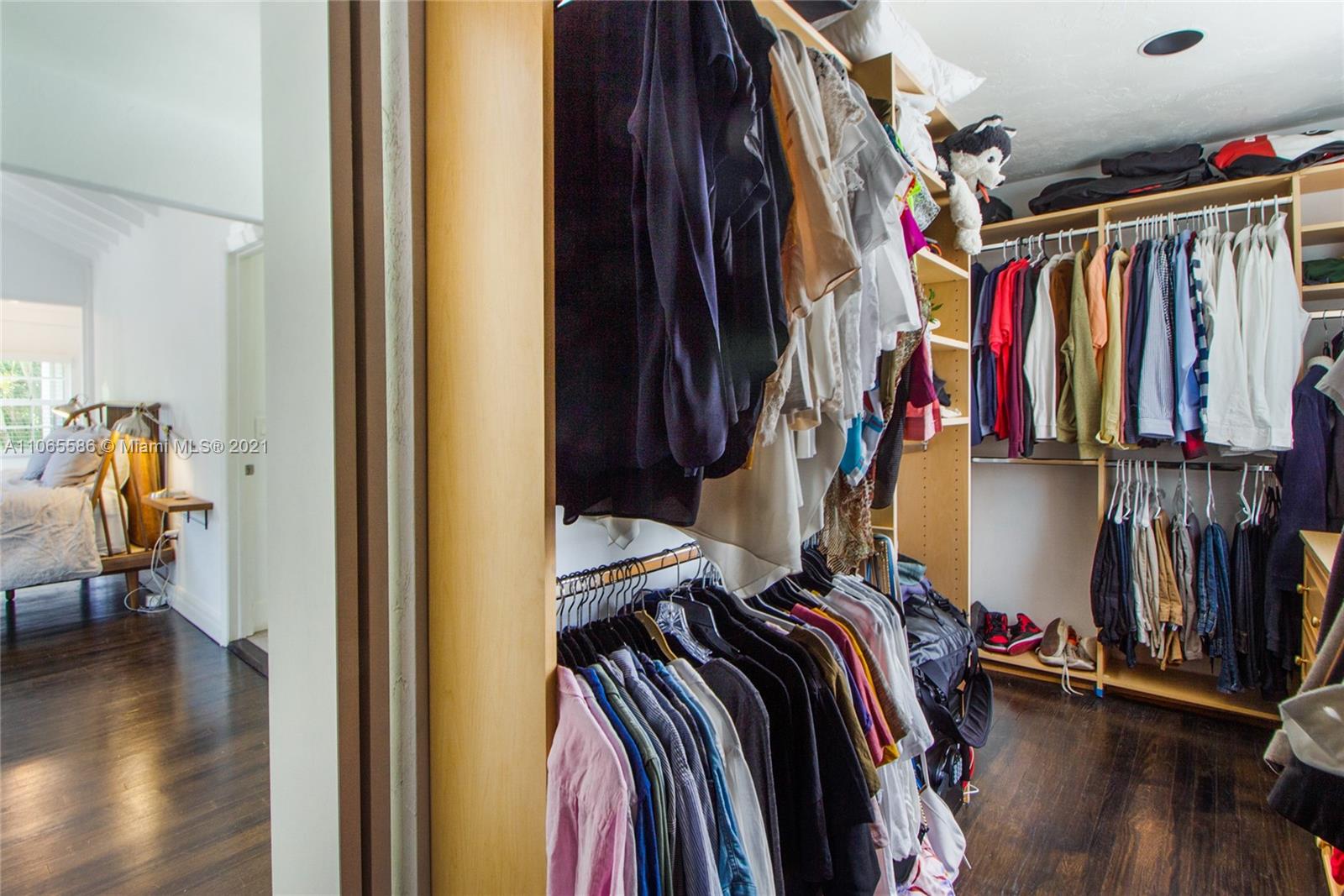 1701 Micanopy Avenue Miami, FL 33133 - Photo 17 of 40 a view of walk in closet with clothes and shoes
