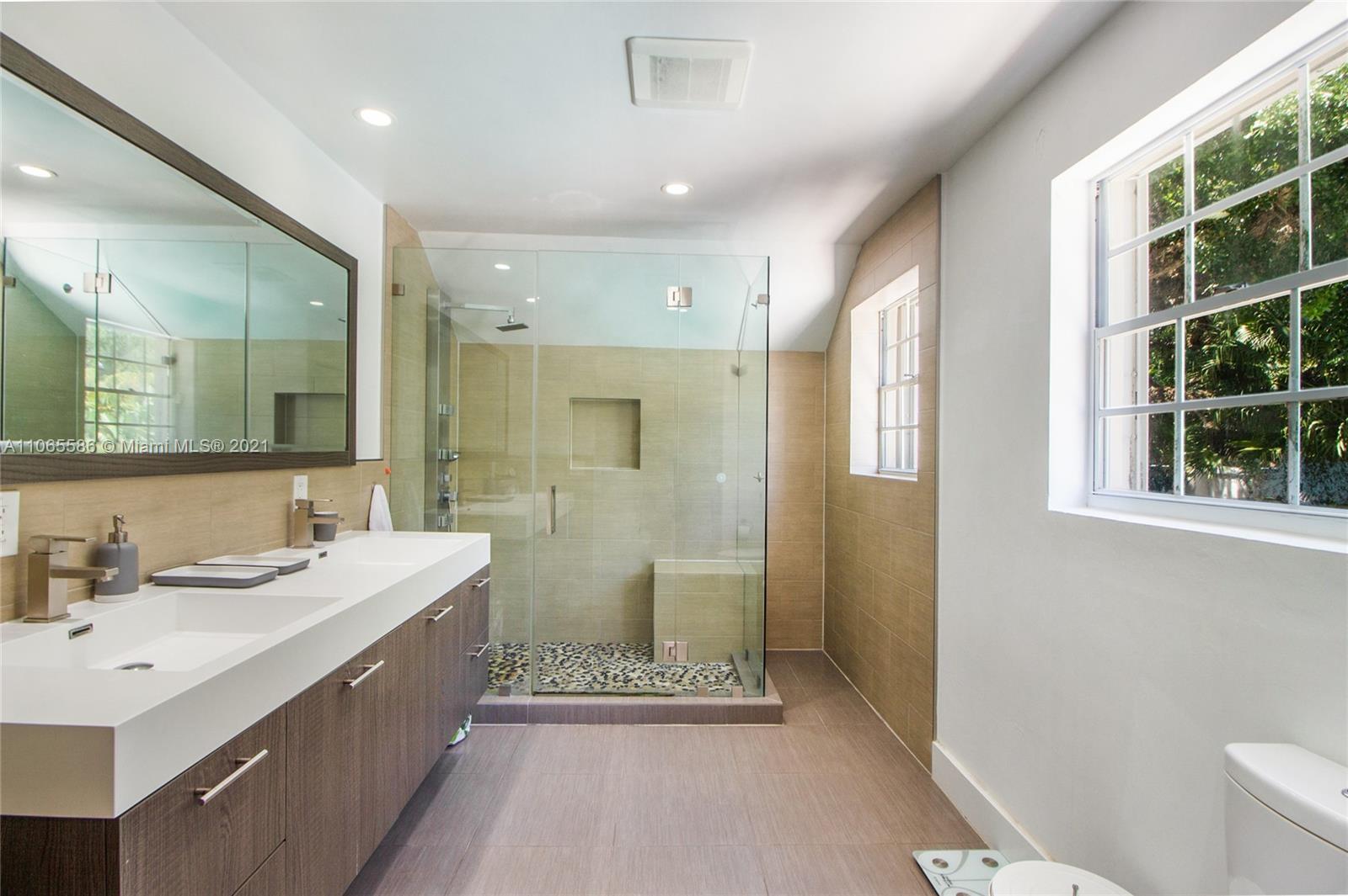 1701 Micanopy Avenue Miami, FL 33133 - Photo 18 of 40 a bathroom with a double vanity sink mirror and shower