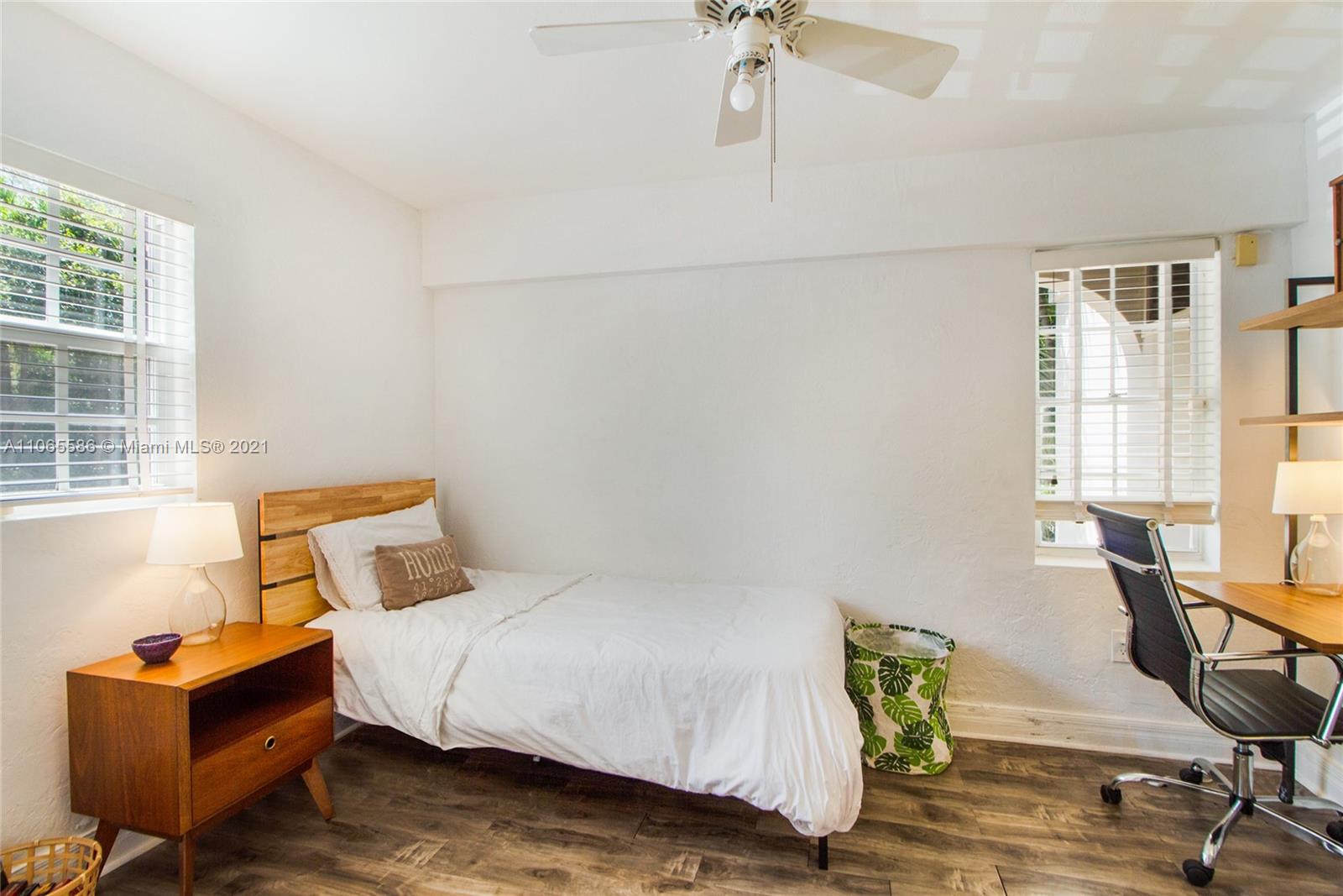 1701 Micanopy Avenue Miami, FL 33133 - Photo 19 of 40 a bedroom with a bed and wooden floor