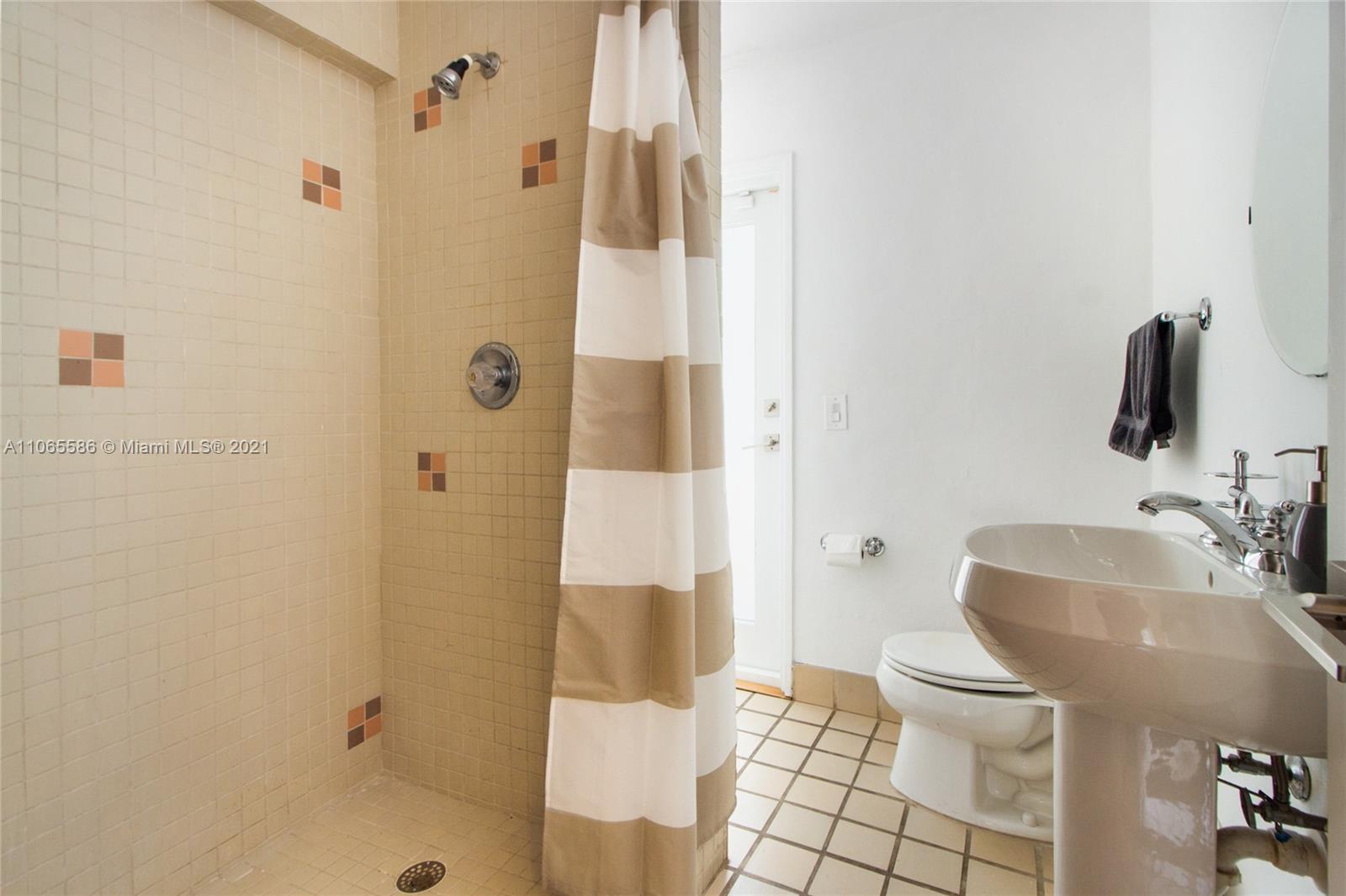 1701 Micanopy Avenue Miami, FL 33133 - Photo 20 of 40 a bathroom with a sink toilet and shower