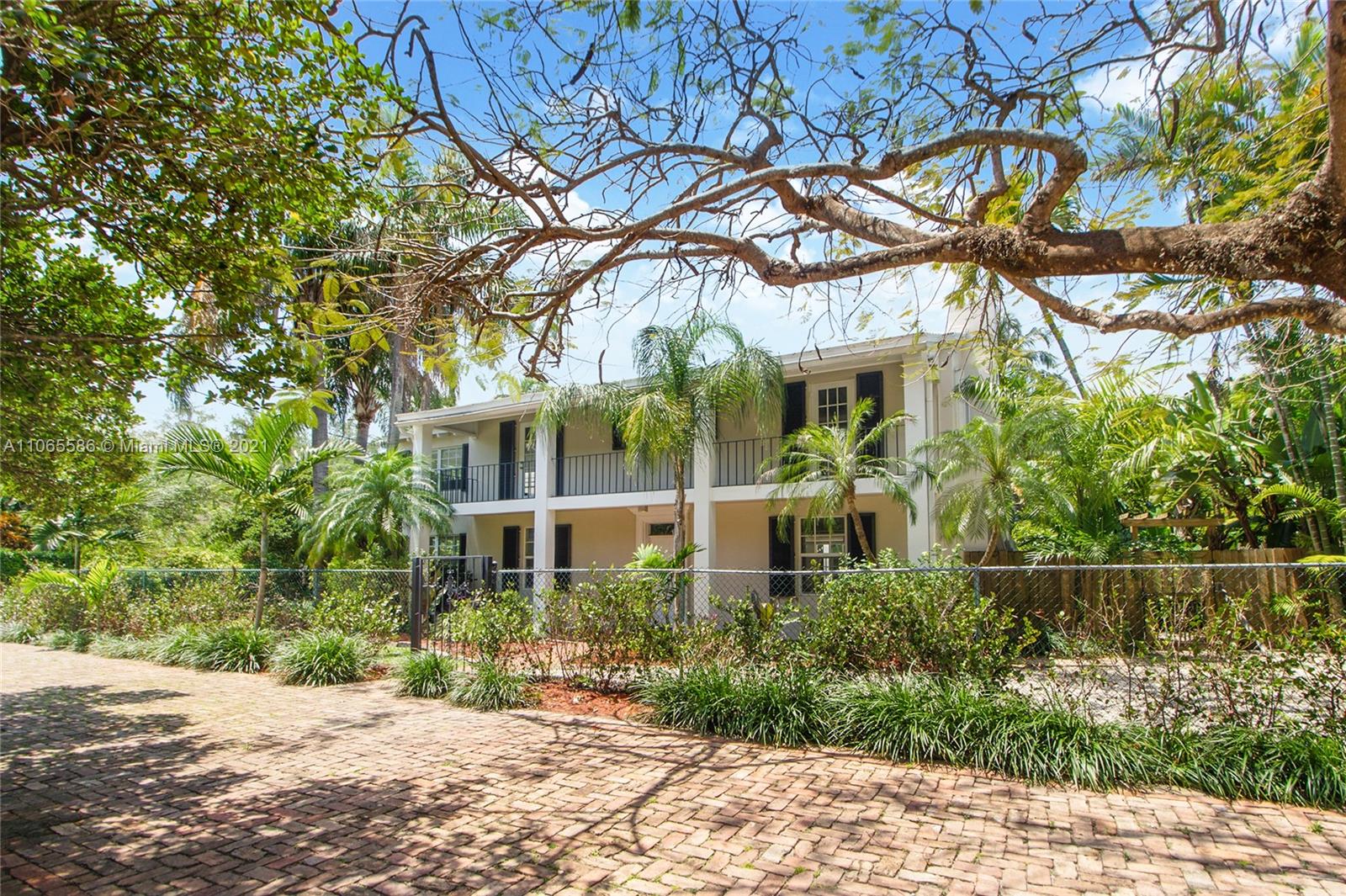 1701 Micanopy Avenue Miami, FL 33133 - Photo 2 of 40 a front view of a house with a garden
