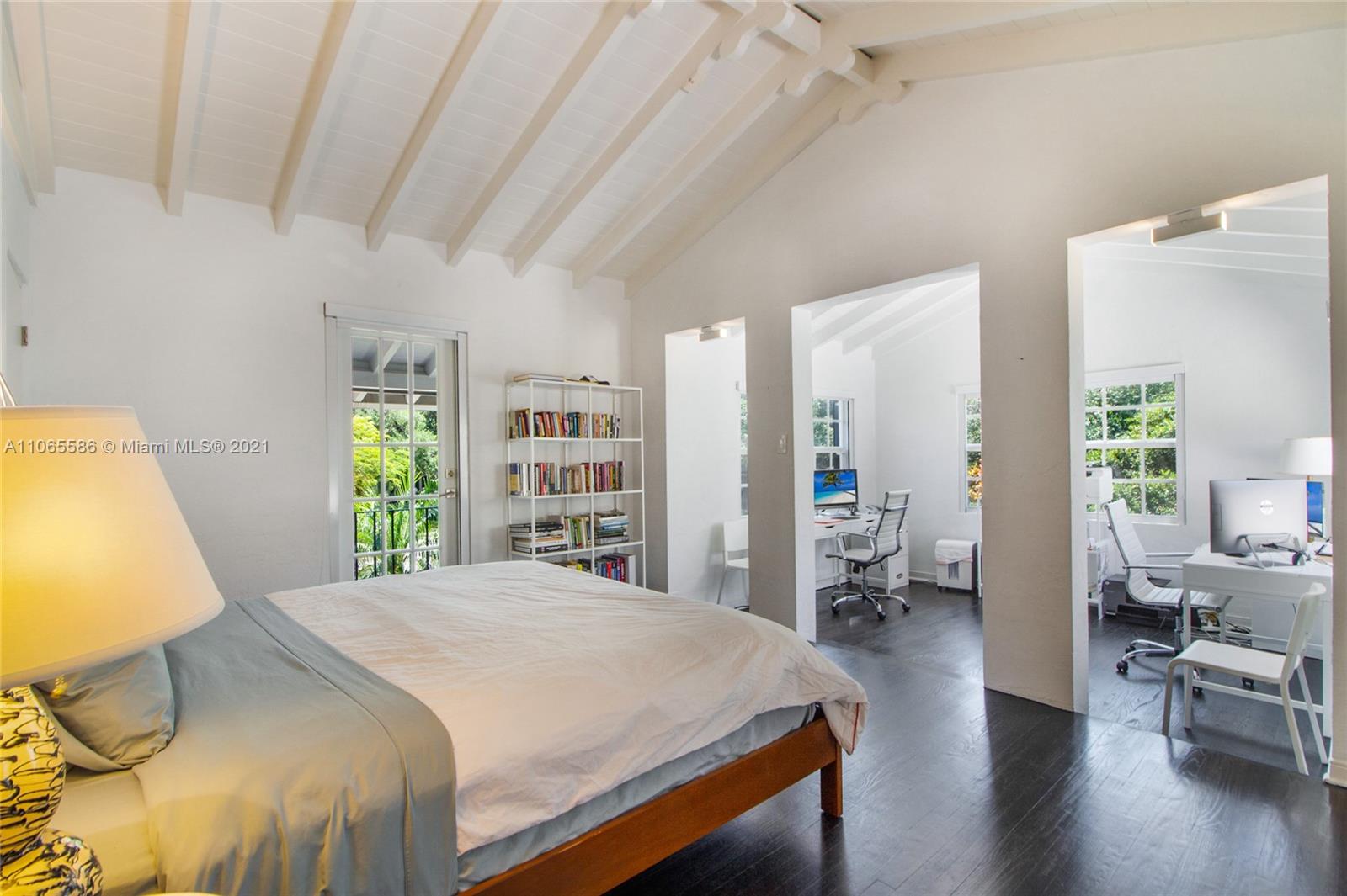 1701 Micanopy Avenue Miami, FL 33133 - Photo 22 of 40 a bedroom with a large bed and wooden floor