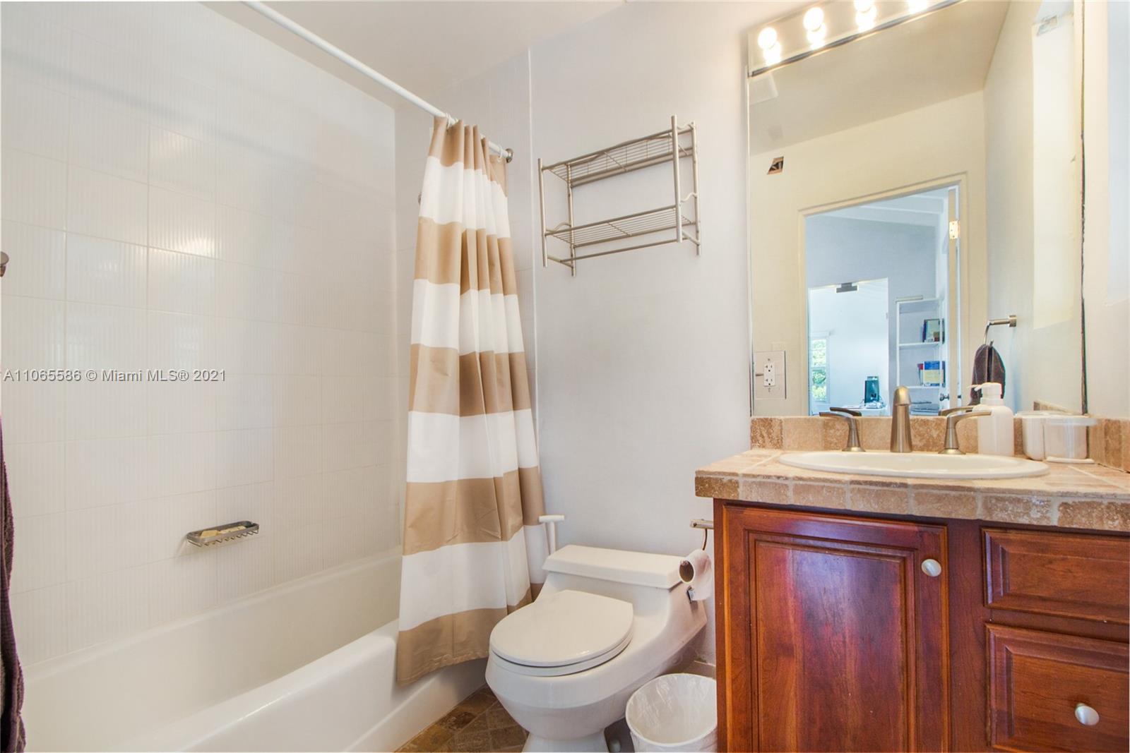 1701 Micanopy Avenue Miami, FL 33133 - Photo 24 of 40 a bathroom with a sink toilet and shower